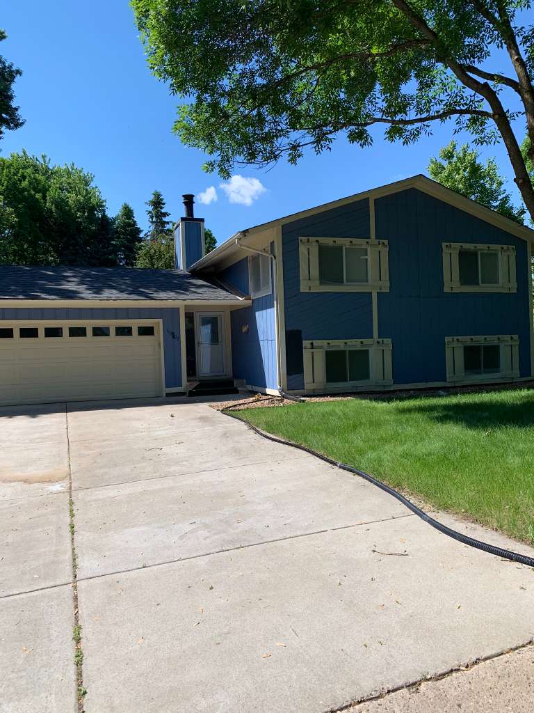 House exterior before — faded blue siding
