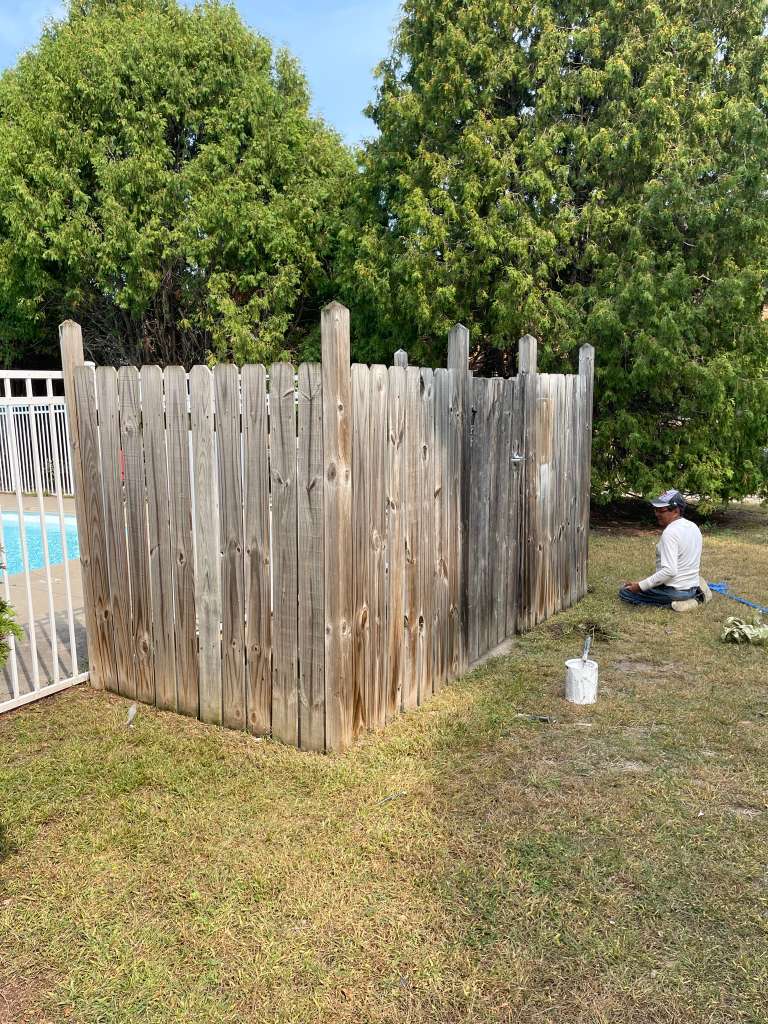 Wood fence before — gray and weathered
