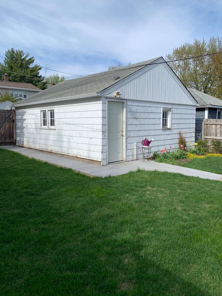 Garage before — peeling and worn paint